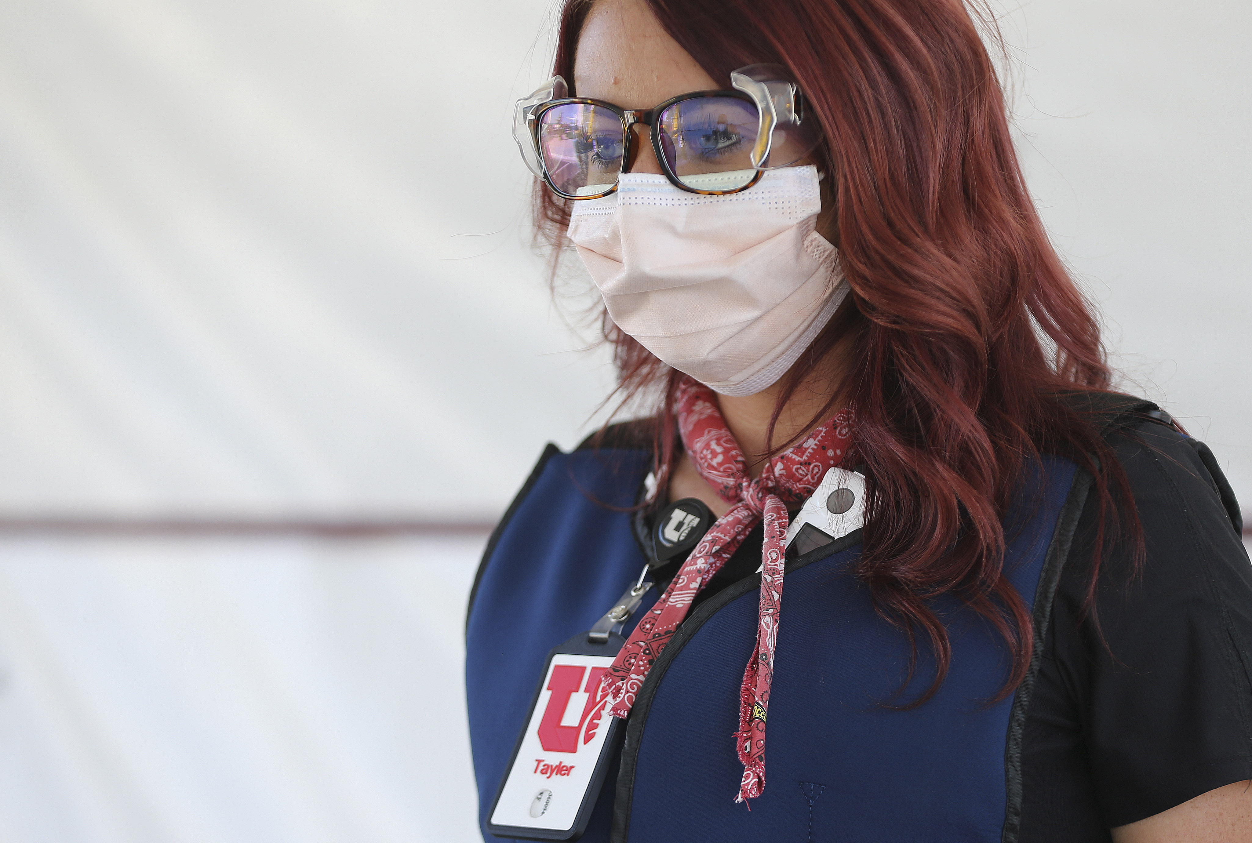 University of Utah Health medical assistant Taylor Gilmore wears a cooling bandana around her neck as she tests for COVID-19 in Farmington on Friday, July 31, 2020. U of U Health is using cooling methods at its testing stations to keep employees comfortable during the extreme heat.