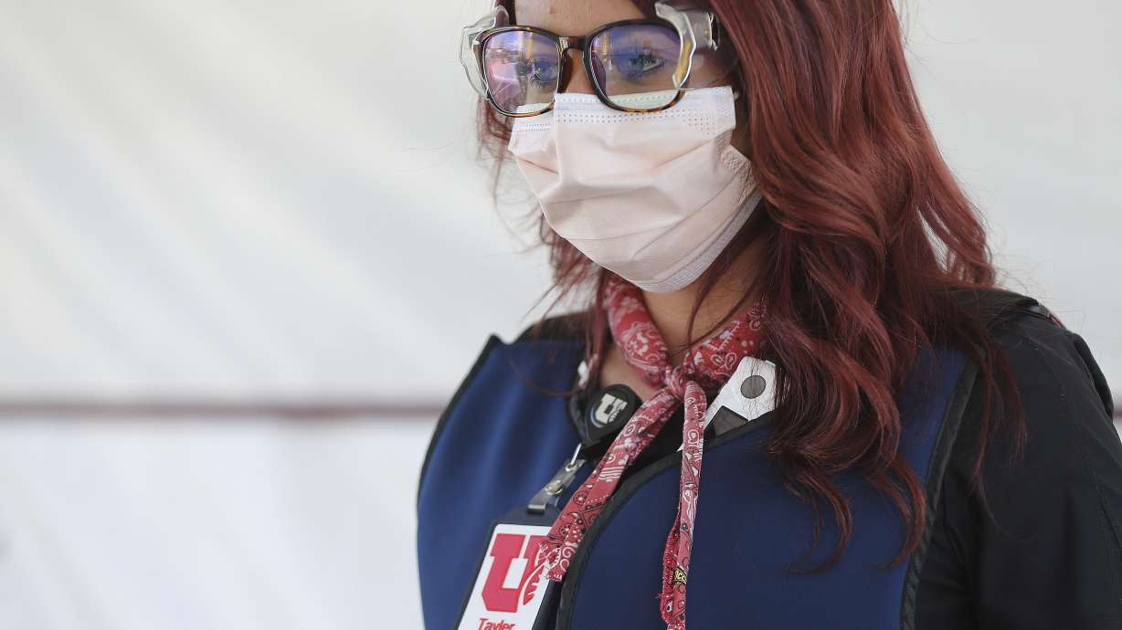 University of Utah Health medical assistant Taylor Gilmore wears a cooling bandana around her neck as she tests for COVID-19 in Farmington on Friday, July 31, 2020. U of U Health is using cooling methods at its testing stations to keep employees comfortable during the extreme heat.