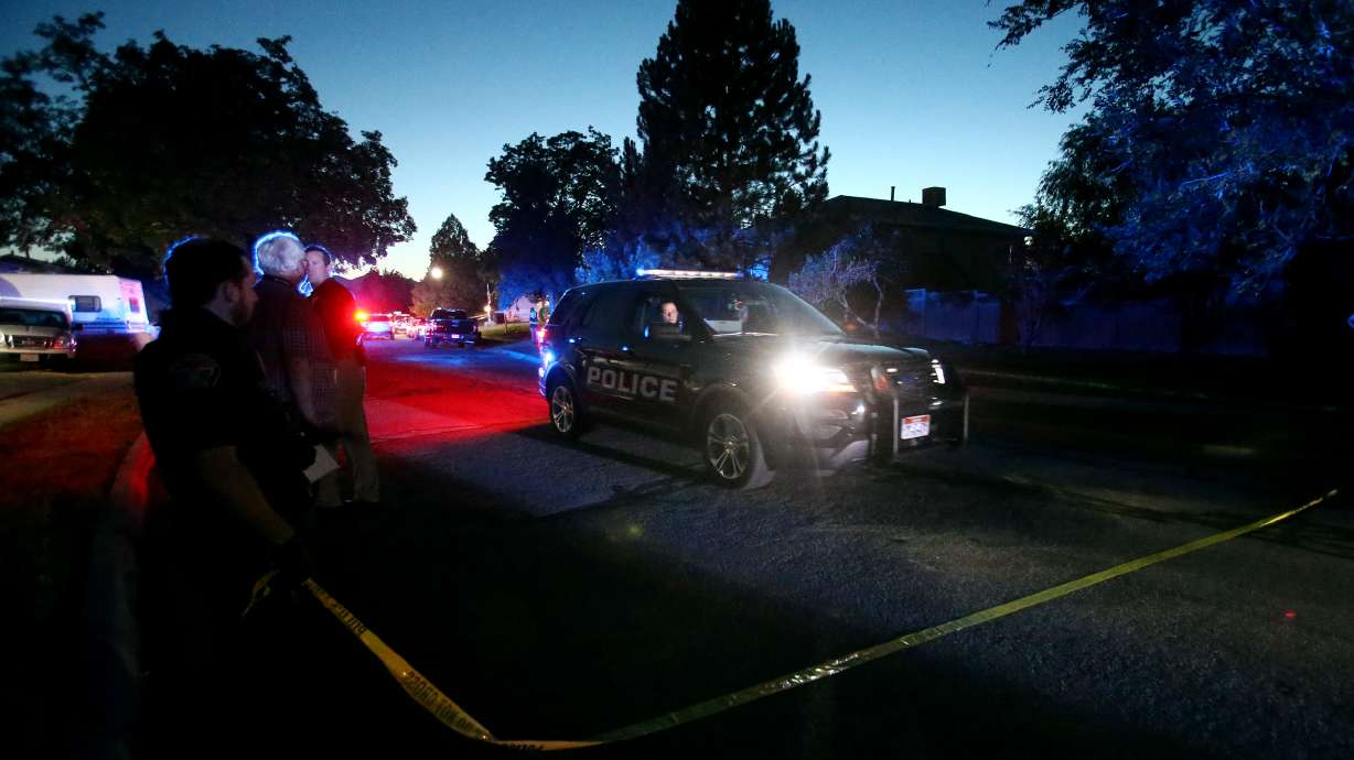 One of two people that were taken into custody is taken away in a vehicle as police officers respond to an officer-involved shooting in West Jordan at 2352 W. 7680 South in West Jordan on Sunday, Aug. 2, 2020.