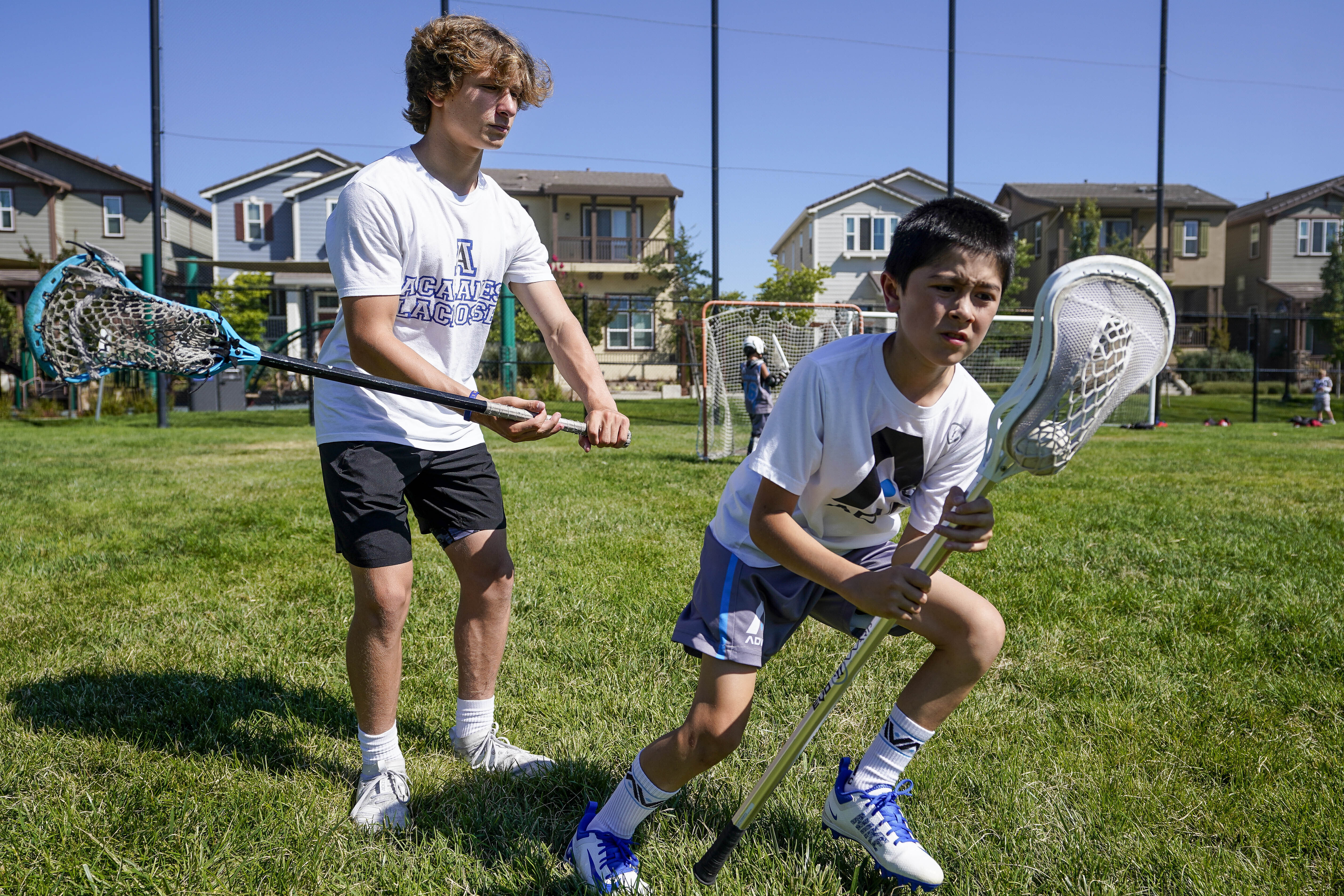 2 teen lacrosse players score goal in fight against hunger