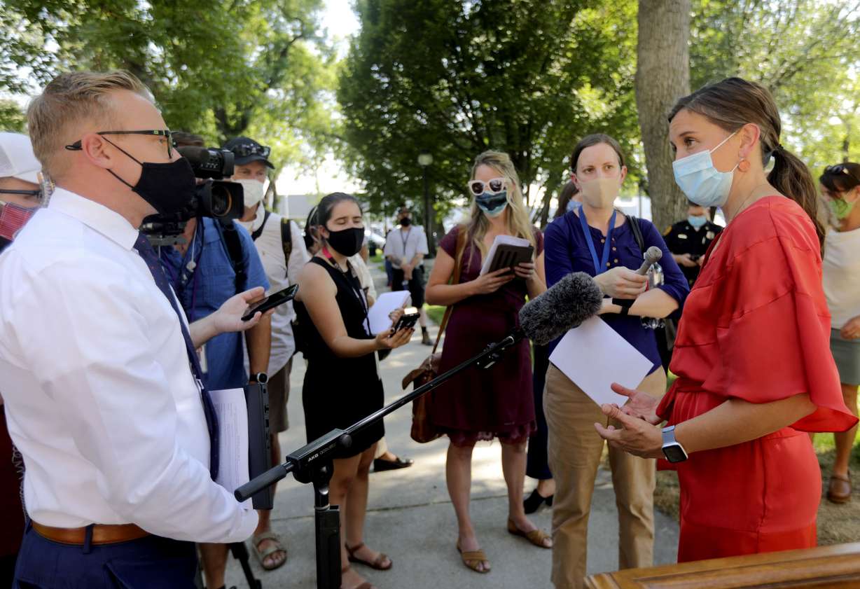 Reporters talk to Salt Lake City Mayor Erin Mendenhall, right, after a press conference about updates to the city's police policies — including de-escalation efforts, use of force, body cameras and consent to search — outside of the City-County Building in Salt Lake City on Monday, Aug. 3, 2020.