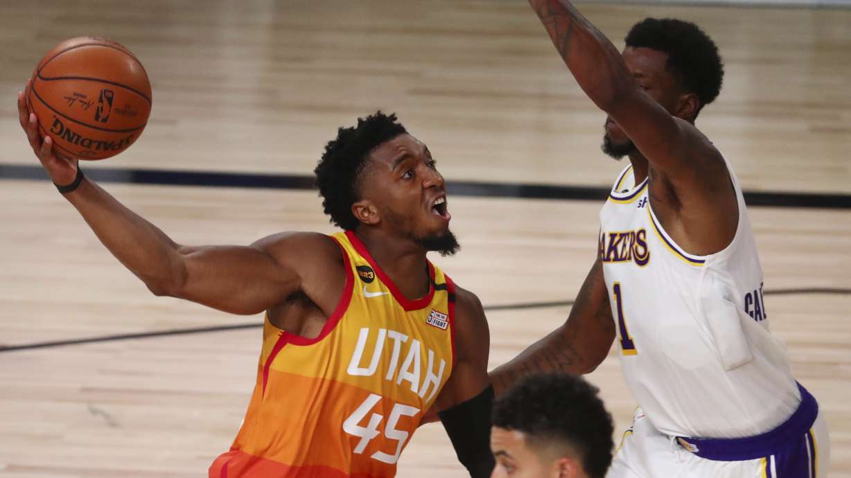 Utah Jazz guard Donovan Mitchell (45) shoots against Los Angeles Lakers guard Kentavious Caldwell-Pope (1) during the second half of an NBA basketball game Monday, Aug. 3, 2020, in Lake Buena Vista, Fla.