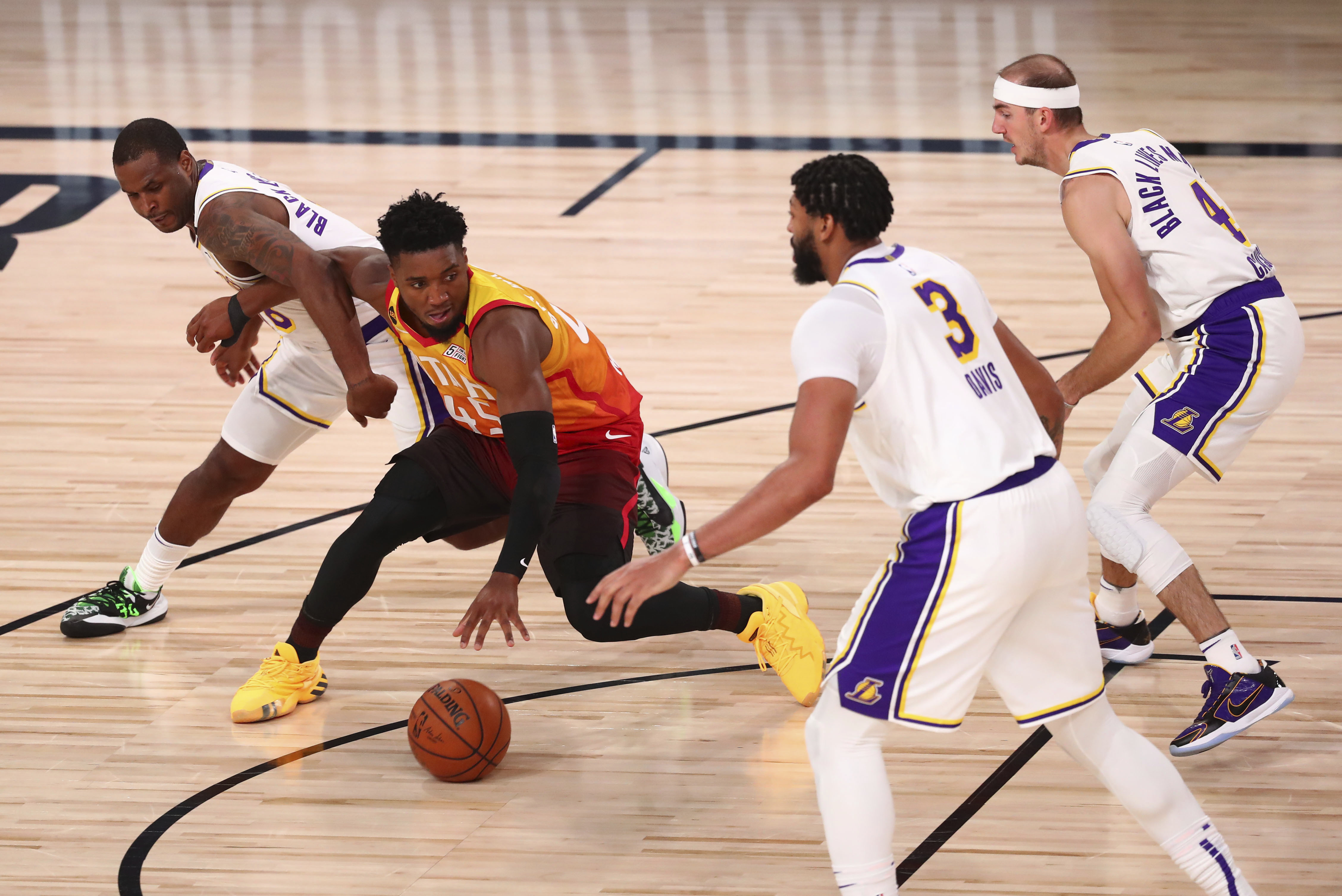 Utah Jazz guard Donovan Mitchell (45) tries to control the ball between Los Angeles Lakers players Dion Waiters (left) , Anthony Davis (3) and Alex Caruso (4)during the second half of an NBA basketball game Monday, Aug. 3, 2020, in Lake Buena Vista, Fla.