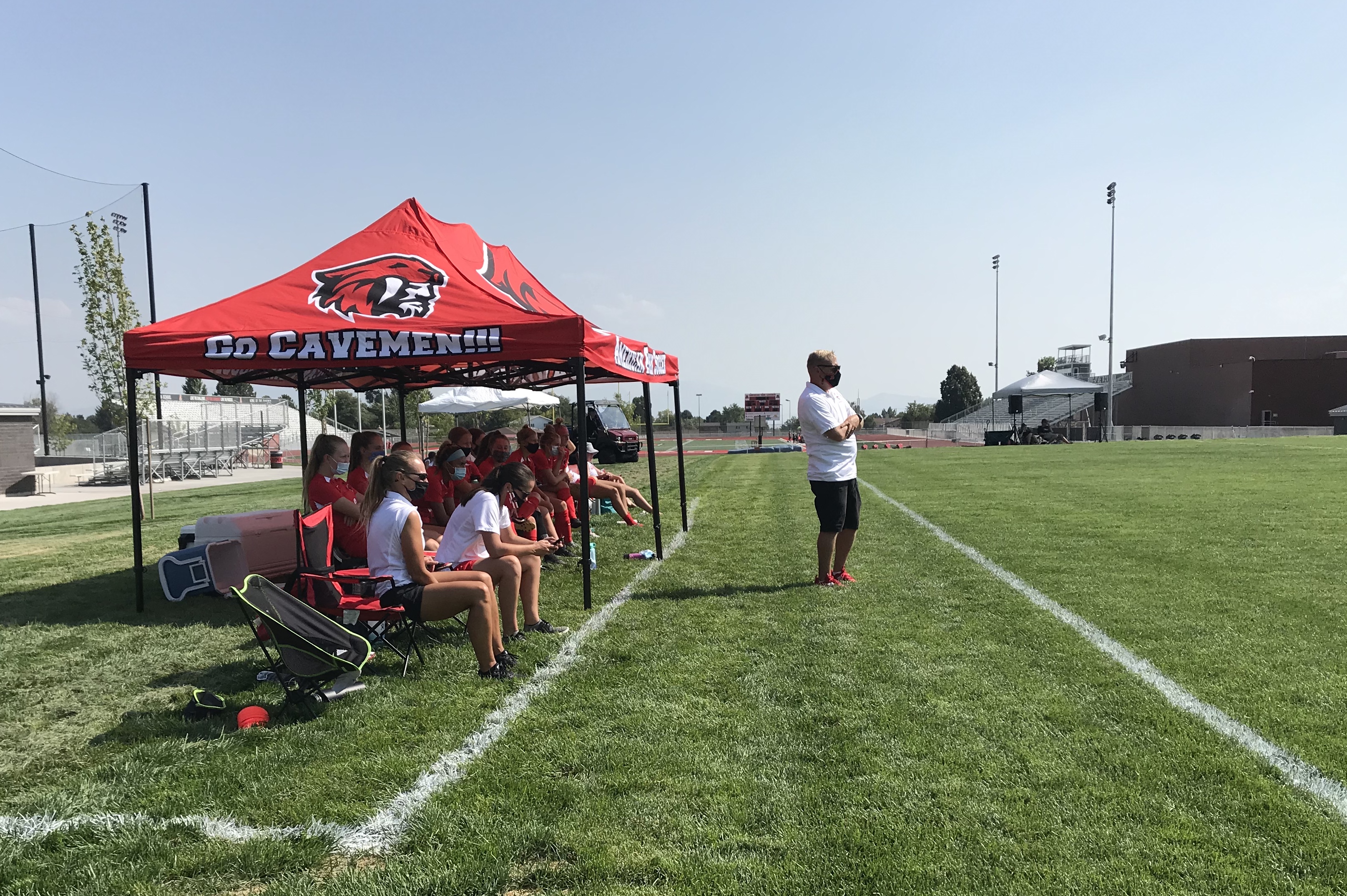 American Fork girls soccer coach Derek Dunn, standing, masks up with his team during a 5-1 win over East in the 2020 season opener, Tuesday, Aug. 4, 2020 in American Fork.