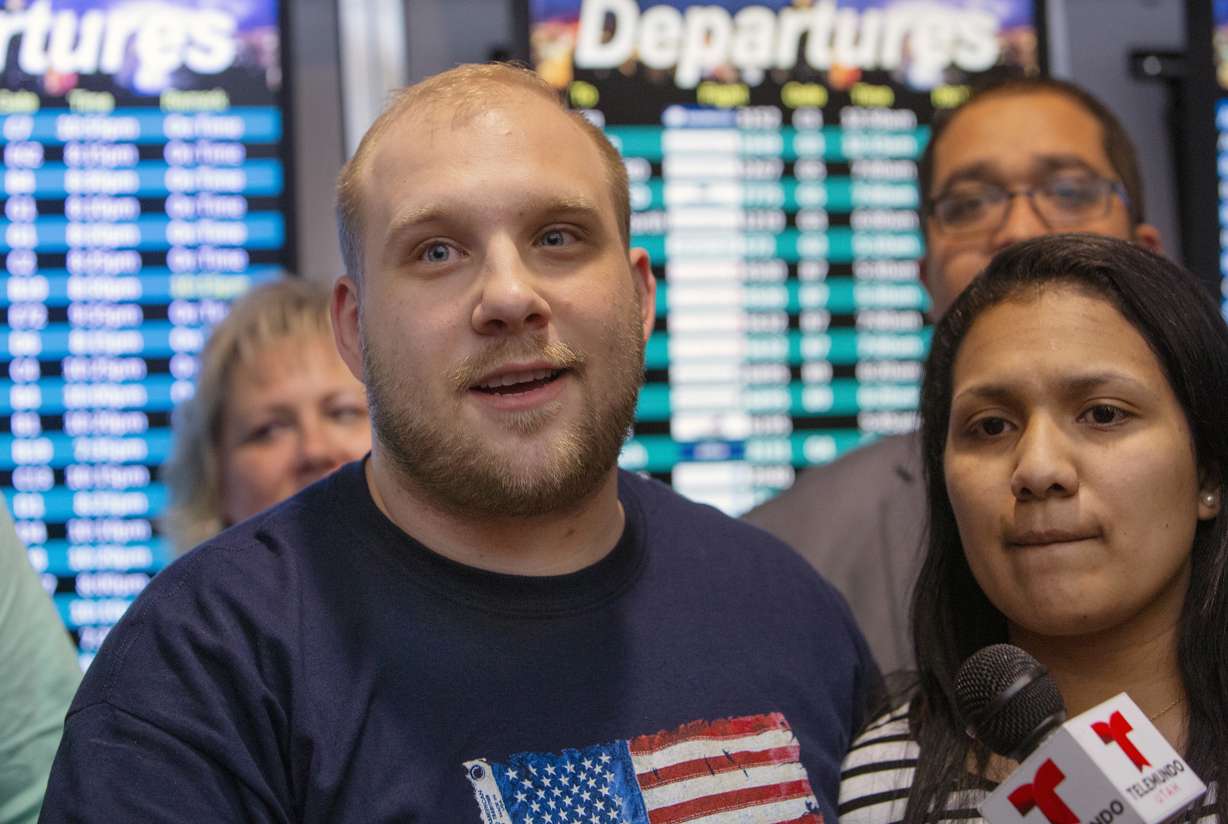 Josh Holt, left, makes a statement to the media with his wife, Thamy, right, upon their arrival in Salt Lake City after receiving medical care and visiting President Donald Trump in Washington on Monday, May 28, 2018.