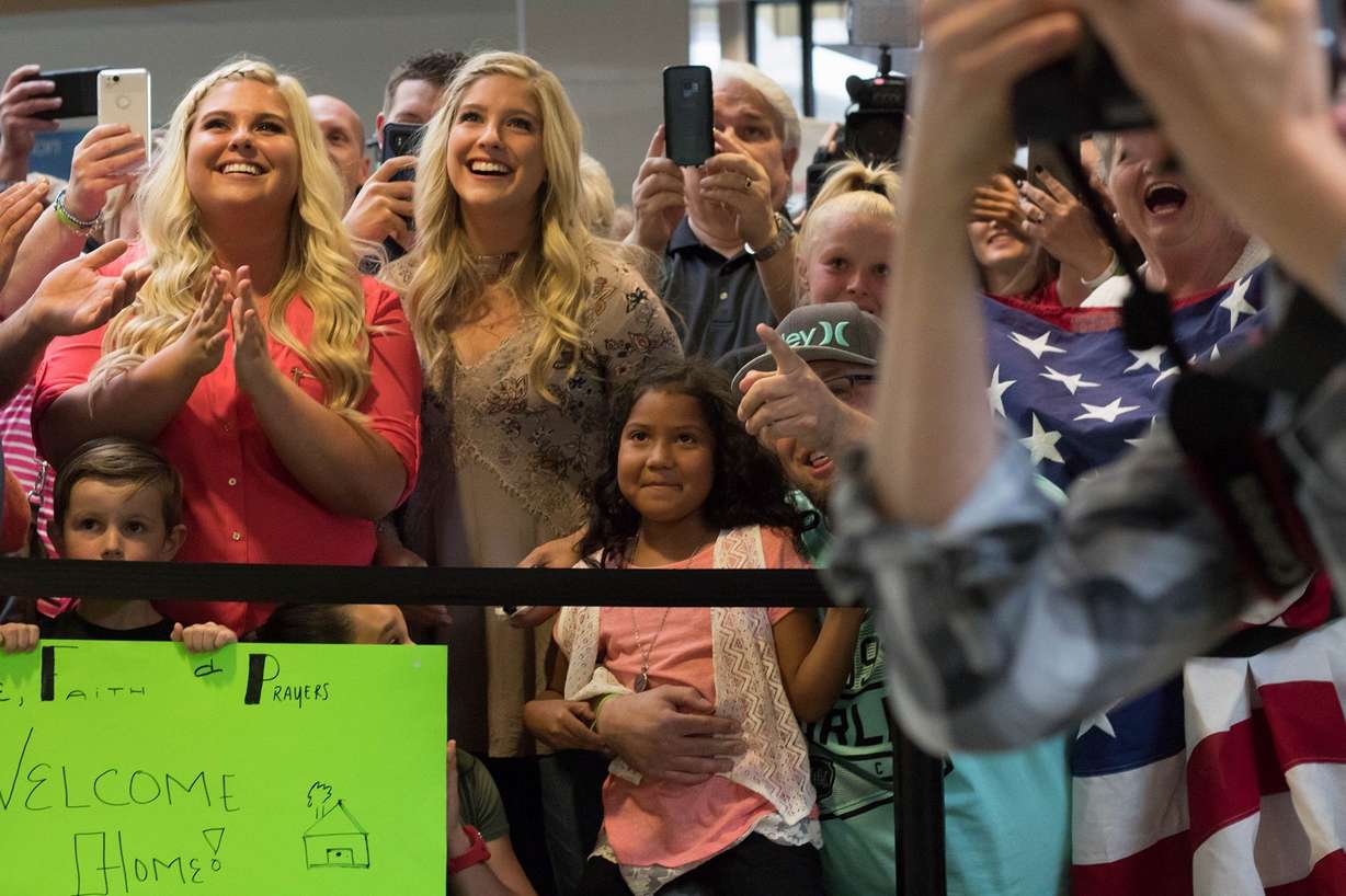 Friends and family react Monday, May 28, 2018, as Josh Holt and his family arrive in Salt Lake City after receiving medical care and visiting President Donald Trump in Washington. Josh and Thamy Holt were locked in a Caracas jail alongside some of the Venezuela’s most-hardened criminals - and President Nicolas Maduro’s top opponents - for what the U.S. government argued were bogus charges of stockpiling weapons.