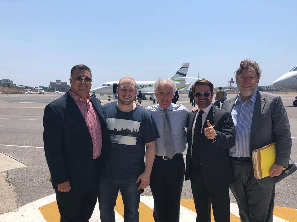 Pedro Diaz-Blum, coordinator of the Boston Group, left, Josh Holt, Sen. Bob Corker, R-Tenn., Carabobo Gov. Rafael Lacava and Senate staffer Caleb McCarry prepare to board the plane to take Josh Holt out of Venezuela.