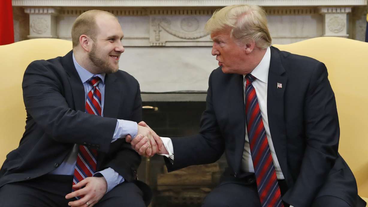 President Donald Trump shakes hands with Josh Holt after his release from prison in Venezuela, in the Oval Office of the White House on Saturday, May 26, 2018, in Washington.