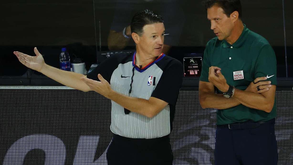 Utah Jazz coach Quin Snyder, right, talks with referee Pat Fraher during the first half of an NBA basketball game against the San Antonio Spurs, Friday, Aug. 7, 2020, in Lake Buena Vista, Fla.