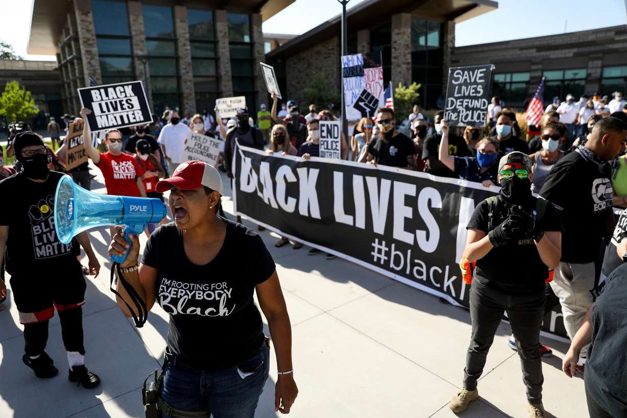 Lex Scott, founder of Black Lives Matter Utah, leads a chant as the organization holds a protest outside the Cottonwood Heights police department on Friday, Aug. 7, 2020.