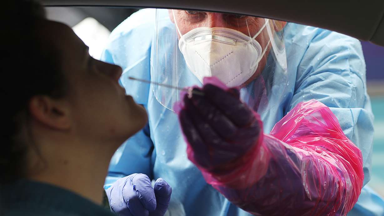 Tess Sullivan receives a COVID-19 test from Brad Langdorf at TestUtah’s COVID-19 mobile testing unit at Provo Towne Centre on Tuesday, July 28, 2020. The units will increase testing access to communities across the state most impacted by the virus.