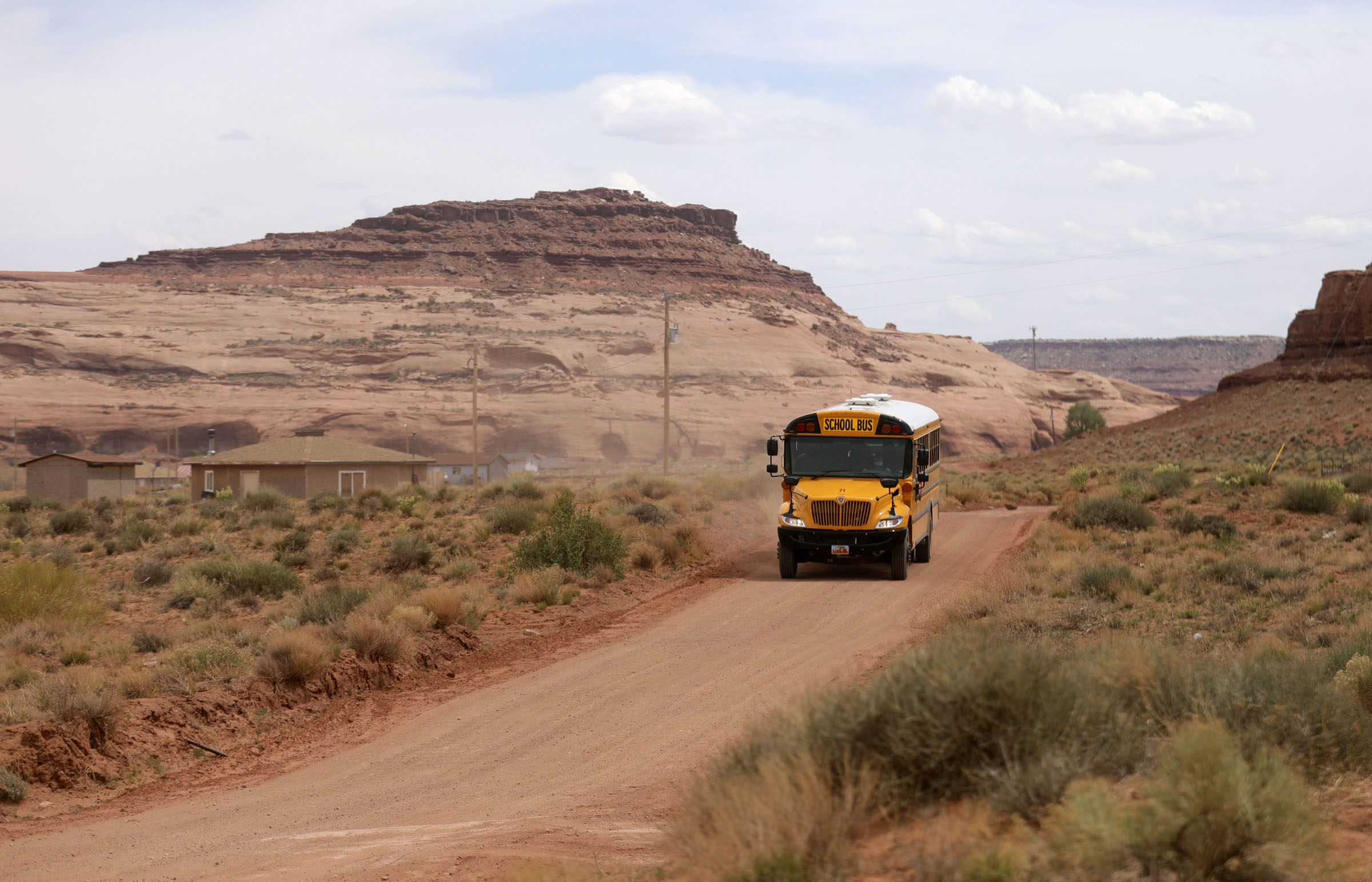 Rosie Fatt drives a school bus to deliver food and homework to students while schools are closed due to the COVID-10 pandemic in Oljato-Monument Valley, San Juan County, on Thursday, April 30, 2020. The Navajo Nation has one of the highest per capita COVID-19 infection rates in the country.