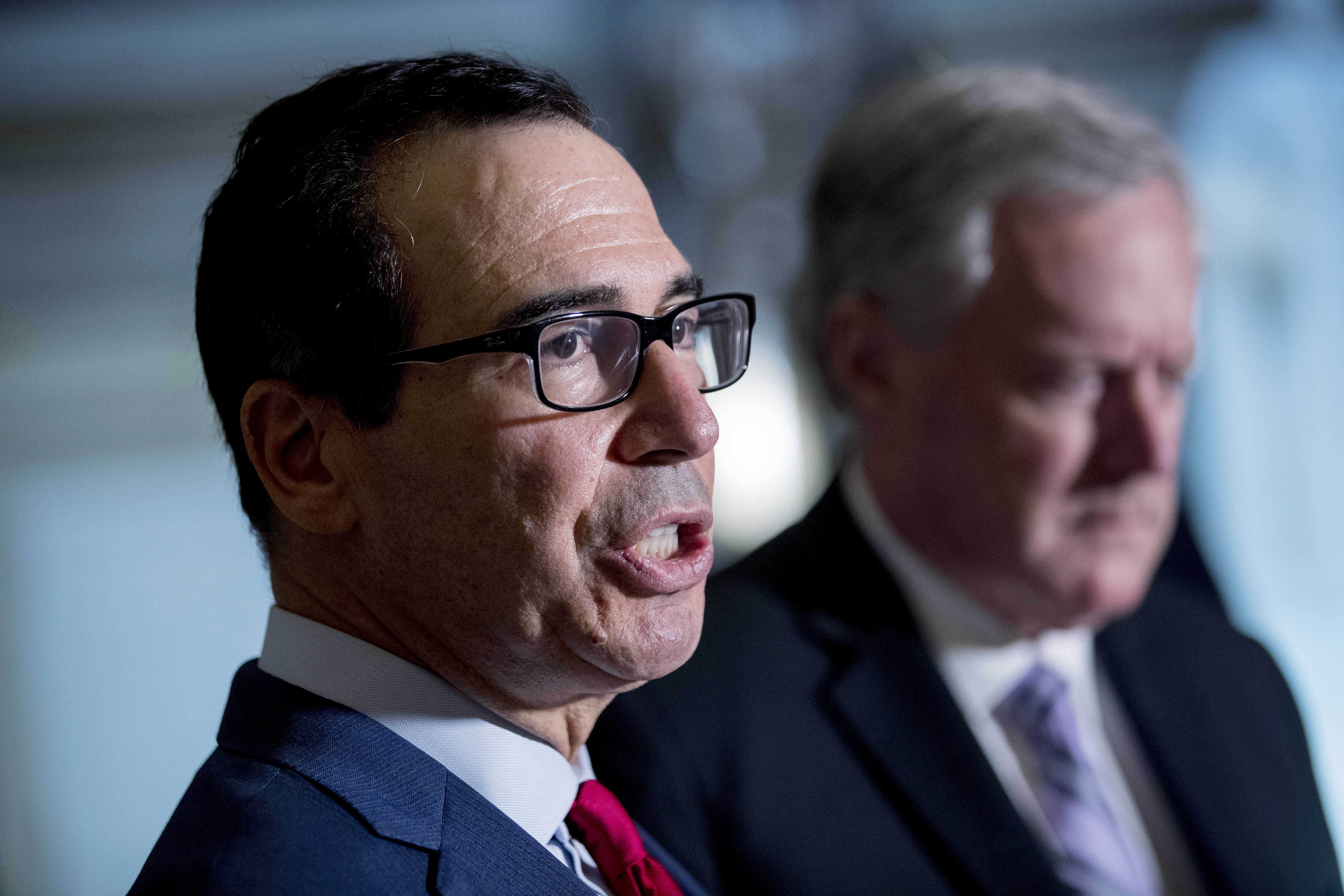 Treasury Secretary Steven Mnuchin, left, accompanied by White House Chief of Staff Mark Meadows, right, speak to reporters following a meeting with House Speaker Nancy Pelosi of Calif. and Senate Minority Leader Sen. Chuck Schumer of N.Y. as they continue to negotiate a coronavirus relief package on Capitol Hill in Washington, Friday, Aug. 7, 2020. (AP Photo/Andrew Harnik) [Aug-09-2020]