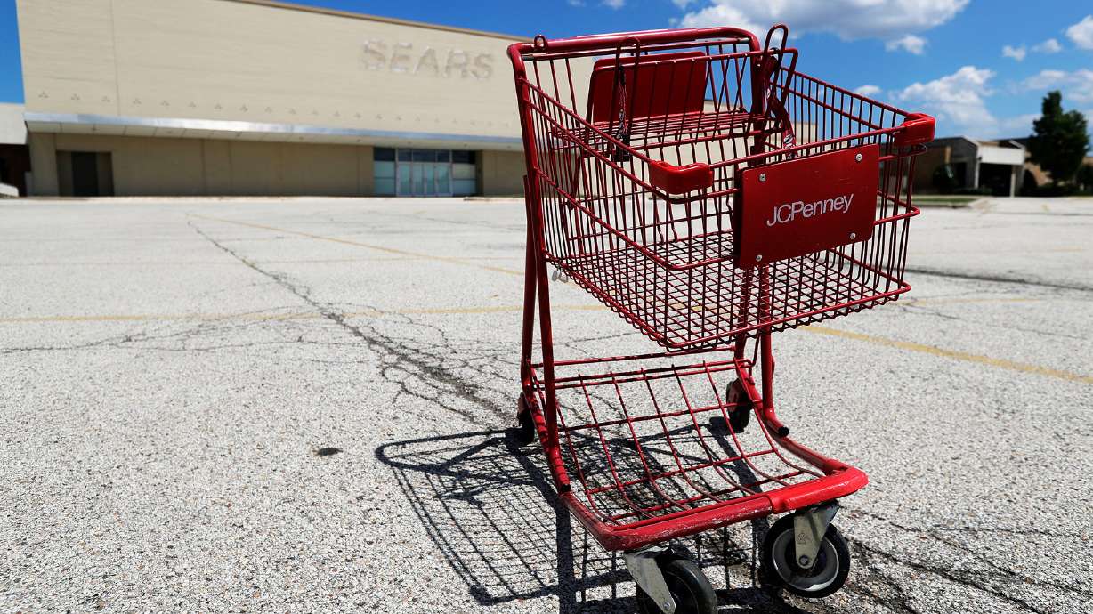 A broken JCPenney shopping cart is seen in an empty parking lot in Niles, Ill., Thursday, June 25, 2020. JCPenney is closing another 13 stores. The department store chain, which filed for bankruptcy last month, is inching toward its target of closing 250 stores about 30% of its network of 846 locations.