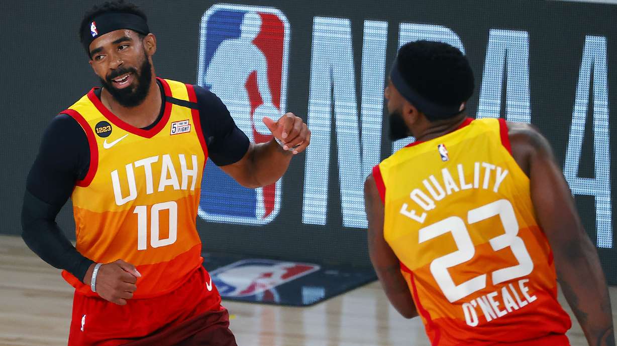 Utah Jazz' Mike Conley (10) celebrates a three-point basket with teammate Royce O'Neale (23) against the Denver Nuggets during the first quarter of an NBA basketball game Saturday, Aug. 8, 2020, in Lake Buena Vista, Fla.
