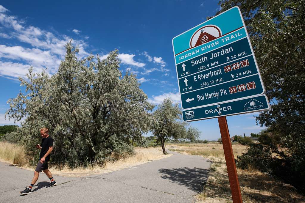 Travis Hurst walks along Jordan River Trail in Draper on Monday, Aug. 10, 2020.