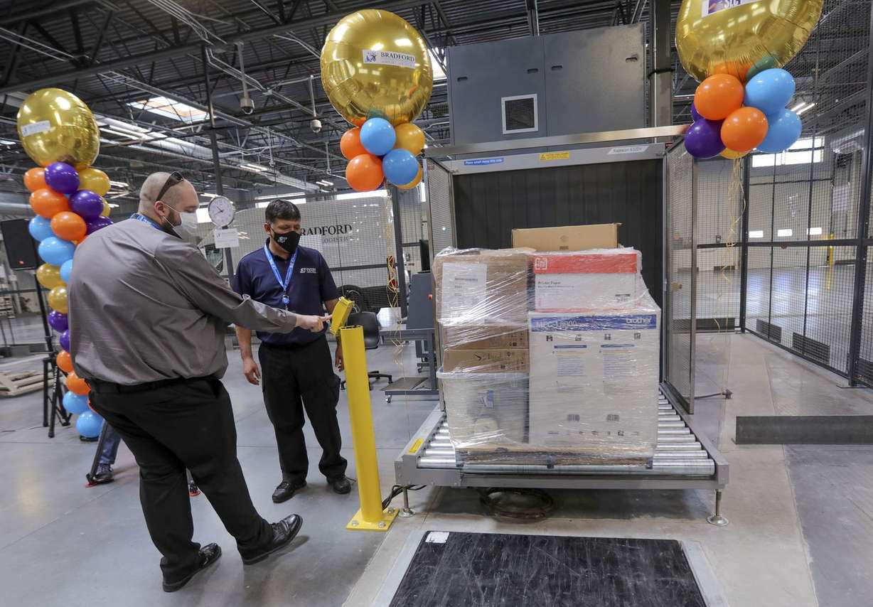 Gage Pruyne and Eduardo Rivera demonstrate loading a Rapiscan cargo X-ray machine to look for prohibited items in pallets during the grand opening of Salt Lake City International Airport’s Central Receiving and Distribution Center in Salt Lake City on Tuesday, Aug. 11, 2020.