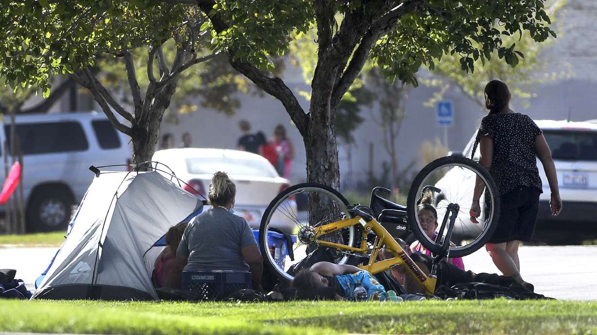 People camp in the park strip along 700 South near State Street in Salt Lake City on Tuesday, Aug. 11, 2020.
