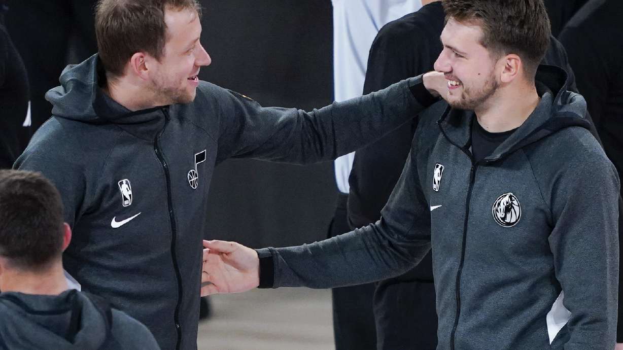 Utah Jazz's Joe Ingles, left, greets Dallas Mavericks' Luka Doncic after an NBA basketball game Monday, Aug. 10, 2020, in Lake Buena Vista, Fla