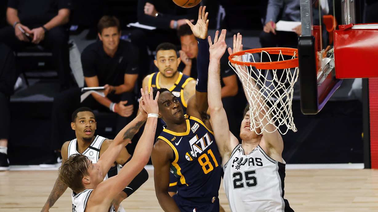 Utah Jazz's Miye Oni (81) shoots against San Antonio Spurs' Jakob Poeltl (25) and Luka Samanic (19) during the third quarter of an NBA basketball game Thursday, Aug. 13, 2020, in Lake Buena Vista, Fla.