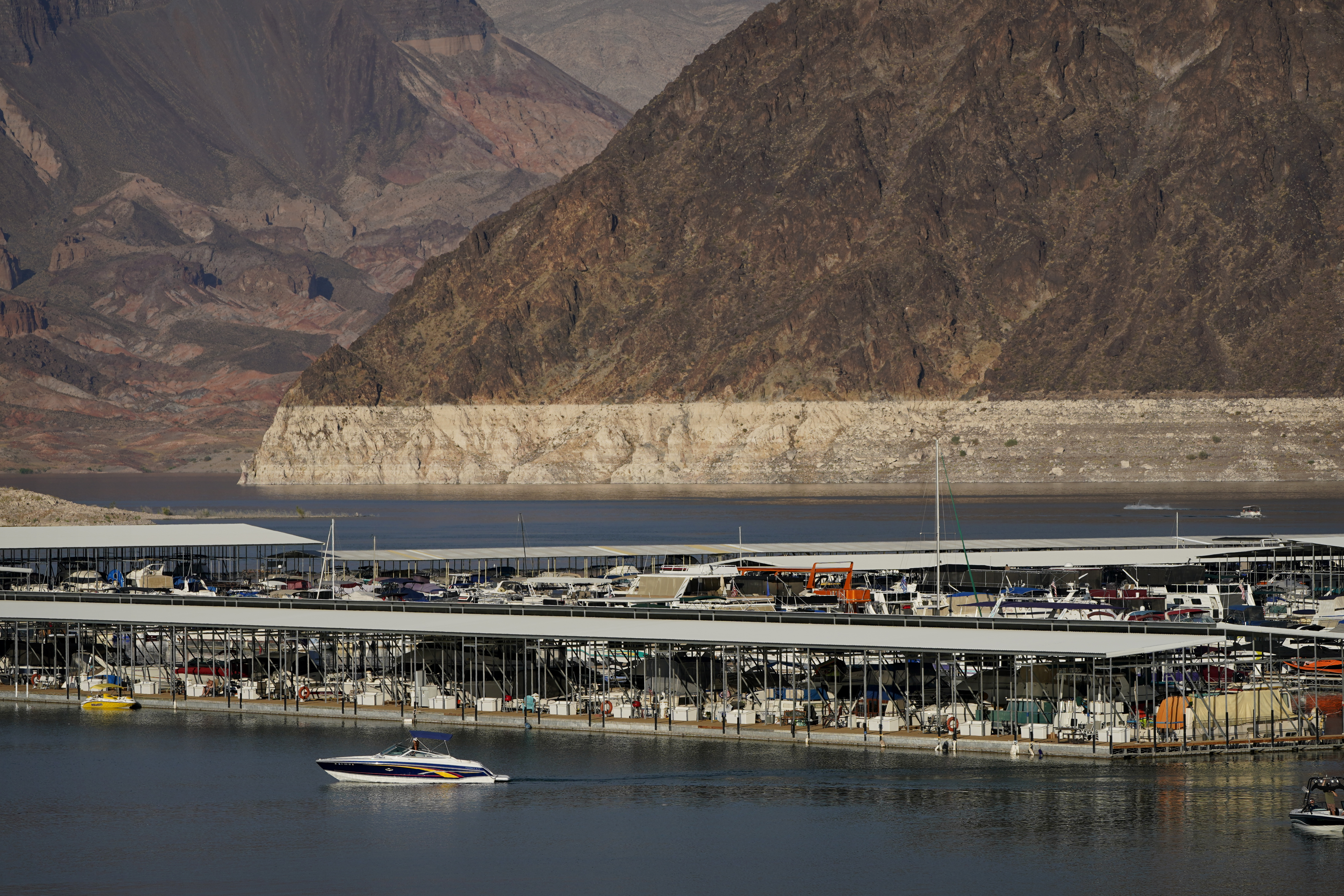 A bathtub ring of light minerals delineates the high water mark on Lake Mead at the Lake Mead National Recreation Area, Thursday, Aug. 13, 2020, near Boulder City, Nev. The U.S. Bureau of Reclamation is expected to release projections that suggest the levels in Lake Powell and Lake Mead dipped slightly compared with last year. (AP Photo/John Locher) [Aug-13-2020]