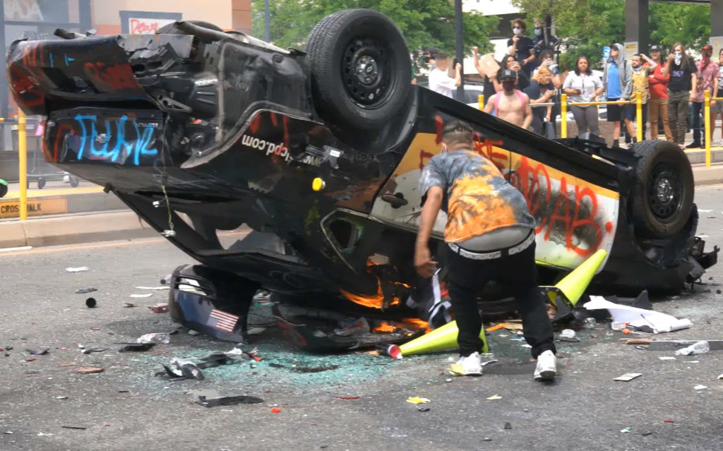 Federal prosecutors say this photo shows Lateesha Richards tossing clothing onto a burning Salt Lake City police car during a riot on May 30, 2020.