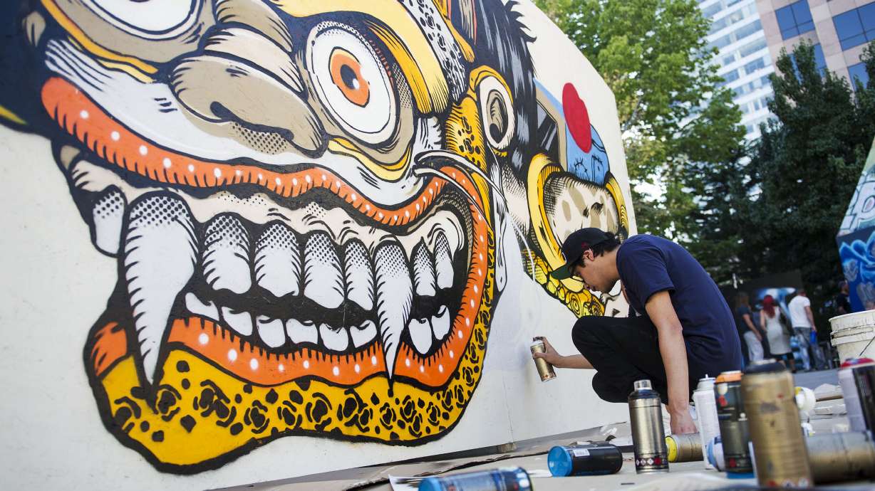 Eduardo Bastida Guzman, of Mexico City, works on his street art project during the Salt Lake City Urban Arts Festival in Salt Lake City on Sunday, Sept. 18, 2016. Bastida said the project took him about six hours to complete.