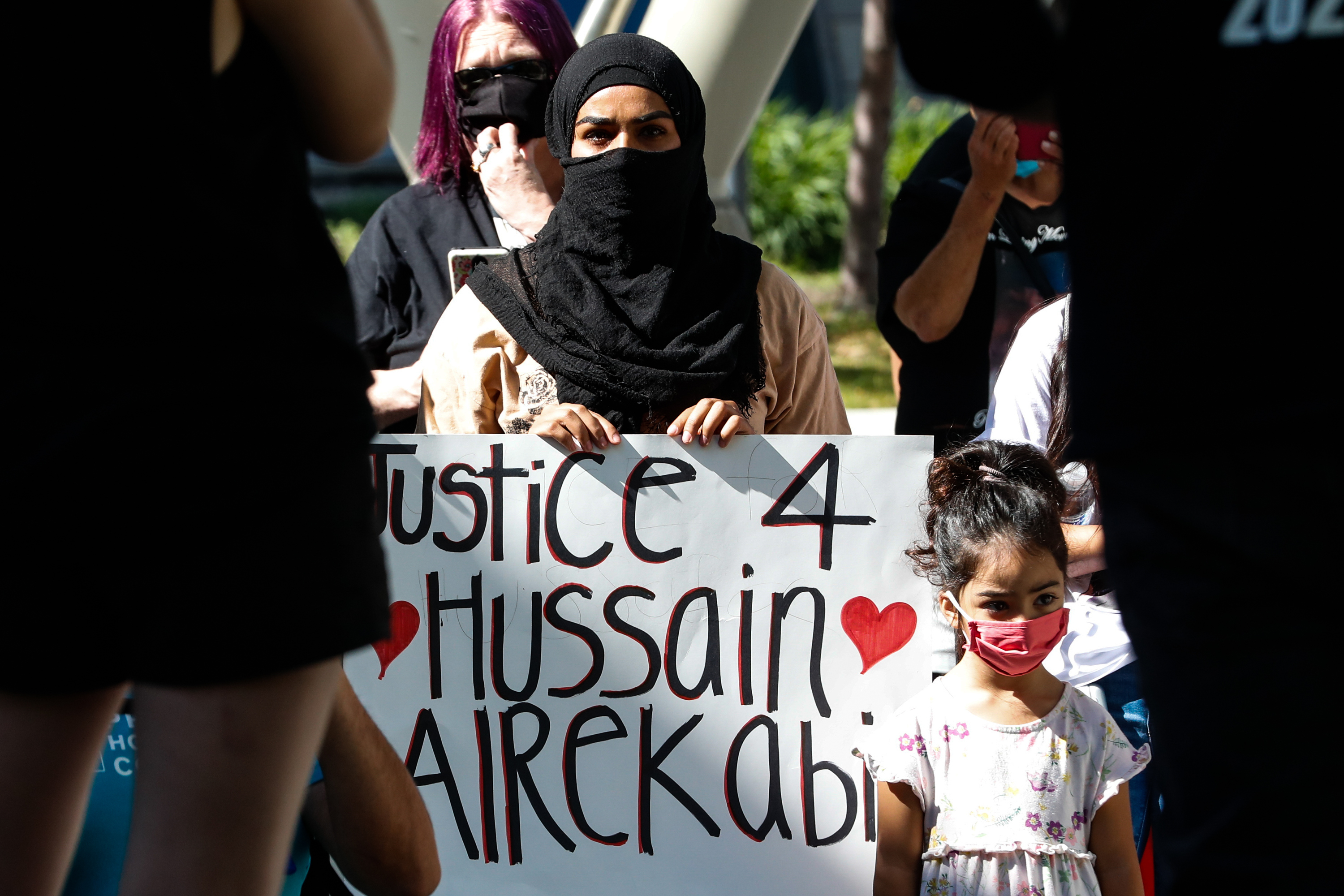 A woman and child participate in a protest in memory of people who have been killed by law enforcement at the Salt Lake City Public Safety Building in Salt Lake City on Saturday, Aug. 15, 2020.
