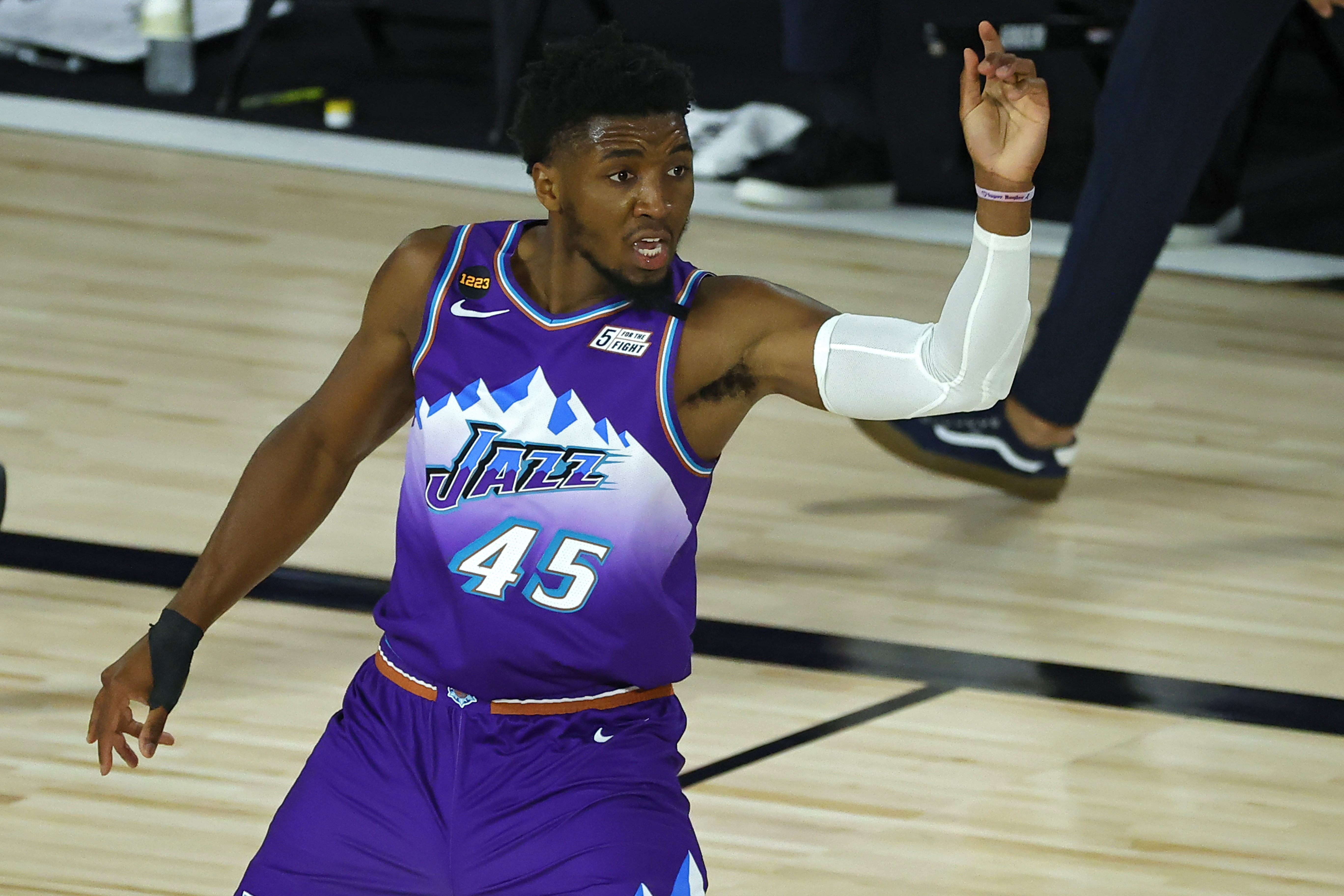 Utah Jazz's Donovan Mitchell reacts after scoring a basket against the Memphis Grizzlies during an NBA basketball game Wednesday, Aug. 5, 2020, in Lake Buena Vista, Fla