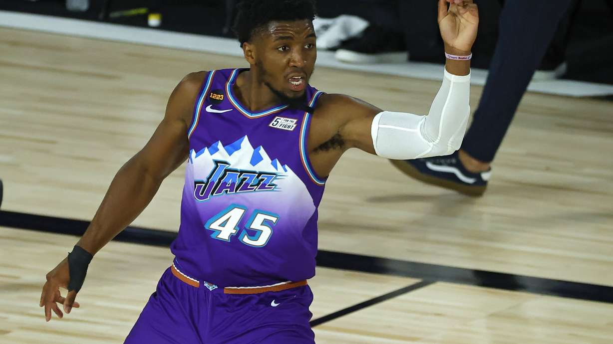 Utah Jazz's Donovan Mitchell reacts after scoring a basket against the Memphis Grizzlies during an NBA basketball game Wednesday, Aug. 5, 2020, in Lake Buena Vista, Fla