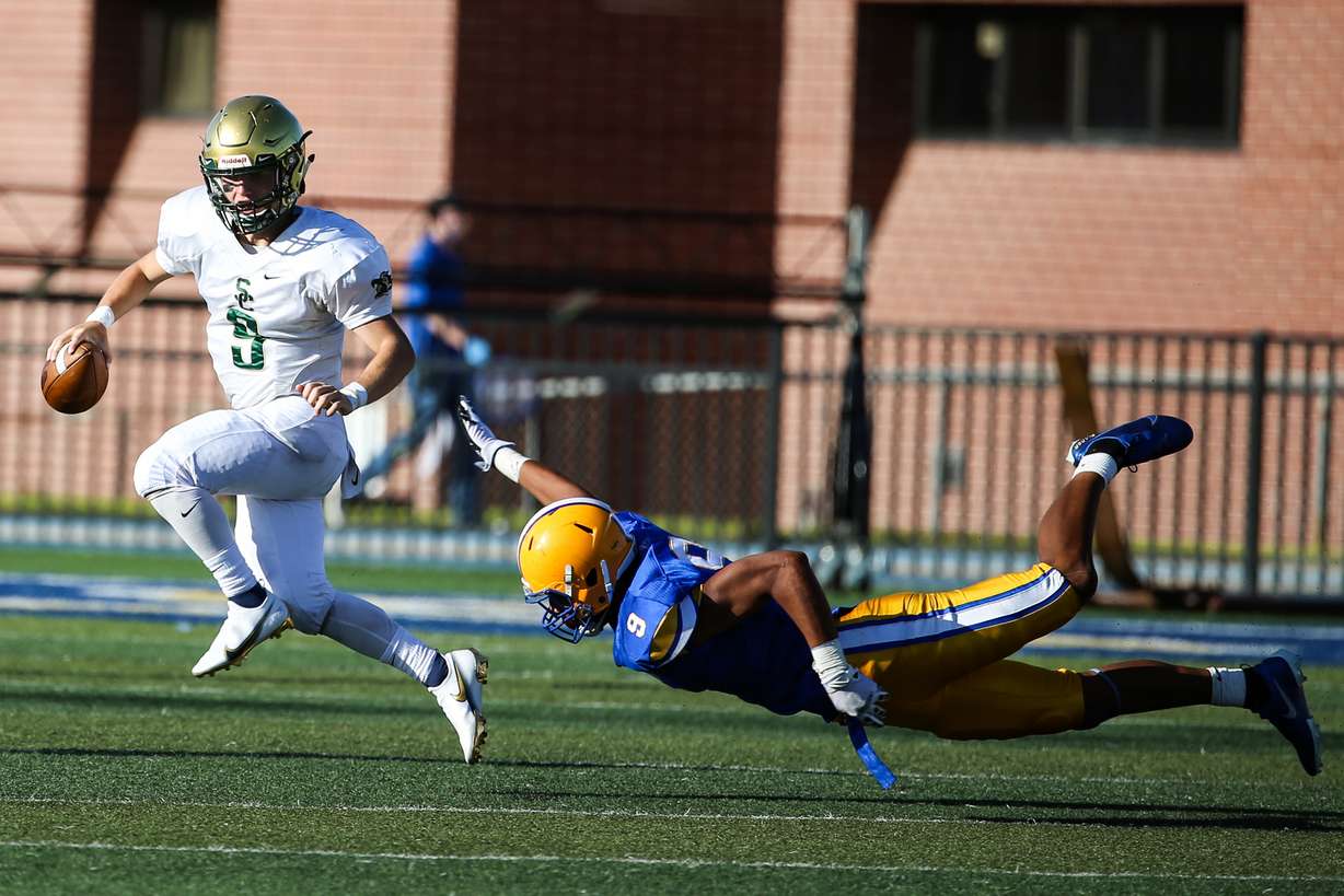 Snow Canyon’s Landon Frei (9) carries the ball while attempting to break the sack from Cyprus’ Fisi Tuatonga (9) during a high school football game at Cyprus High School in Magna on Friday, Aug. 14, 2020. Two positive cases were later identified from the Pirates' varsity program, but the Salt Lake County Health Department did not determined a need to shut down football after contact tracing measures were followed.