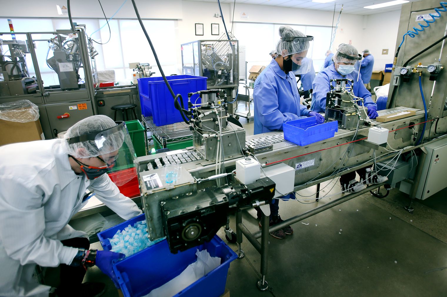 Workers assemble SDNA-1000 saliva collection devices for COVID-19 testing at Spectrum Solutions in Draper on Monday, Aug. 17, 2020.