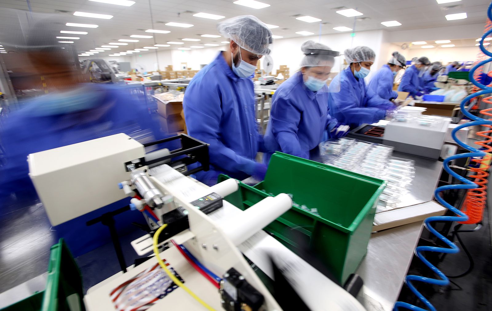 Workers package SDNA-1000 saliva collection devices for COVID-19 testing at Spectrum Solutions in Draper on Monday, Aug. 17, 2020.