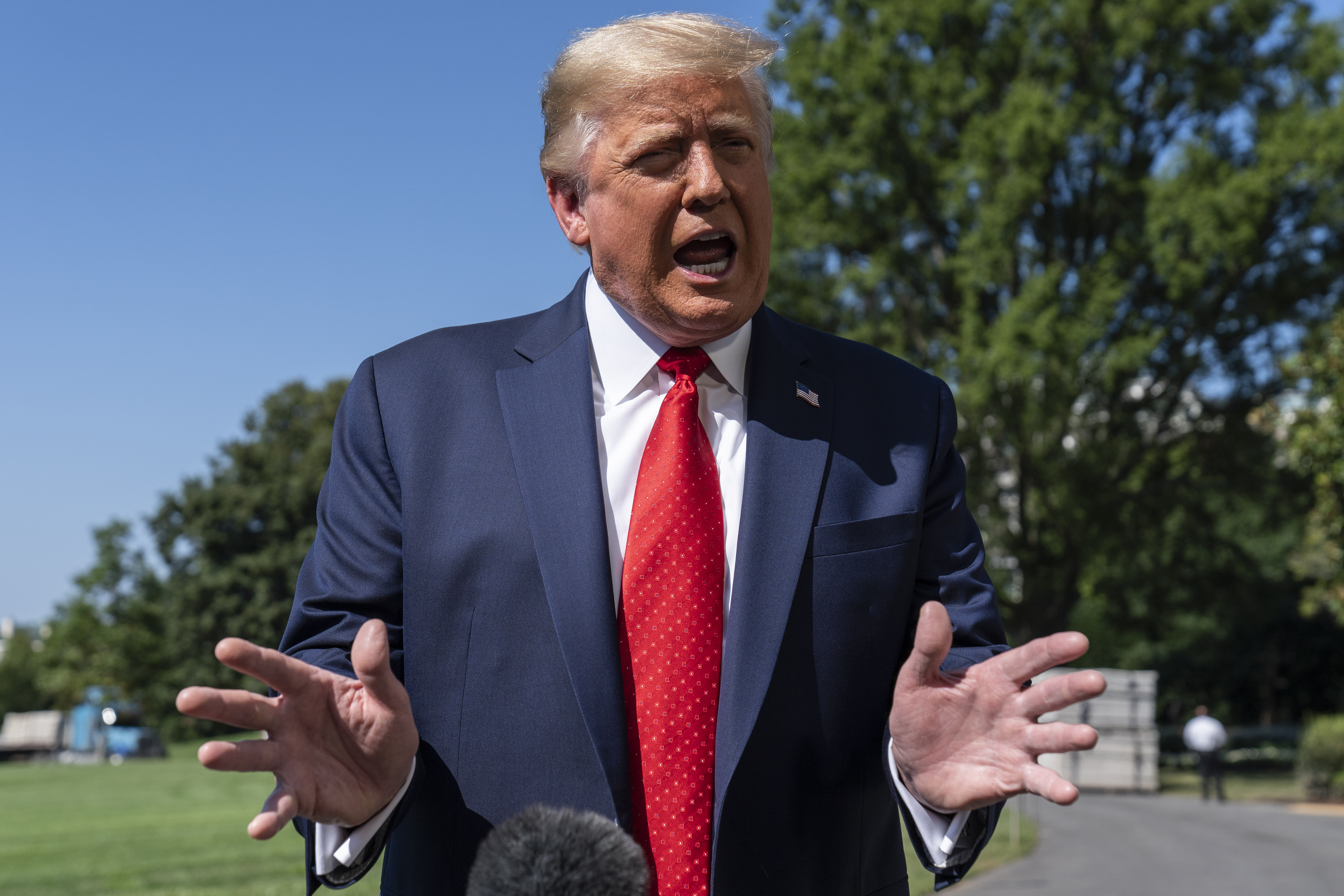 President Donald Trump speaks with reporters as he walks to Marine One on the South Lawn of the White House, Monday, Aug. 17, 2020, in Washington. Trump is en route to Minnesota and Wisconsin. (AP Photo/Alex Brandon) [Aug-17-2020]