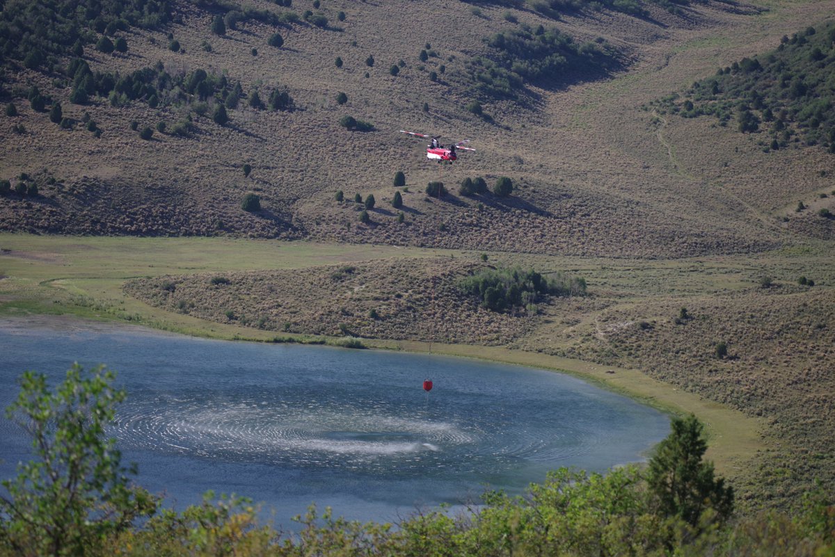 A firefighting helicopter is seen picking up water to drop on the Cowboy Fire near Salina on Tuesday, August 18, 2020.