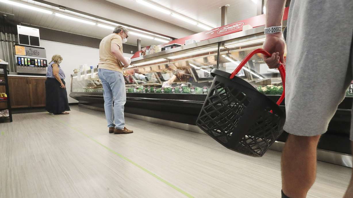 Shoppers pick out items at Snider Bros. Meats in Holladay on Thursday, June 25, 2020. The store currently requires all customers to wear a mask while shopping.