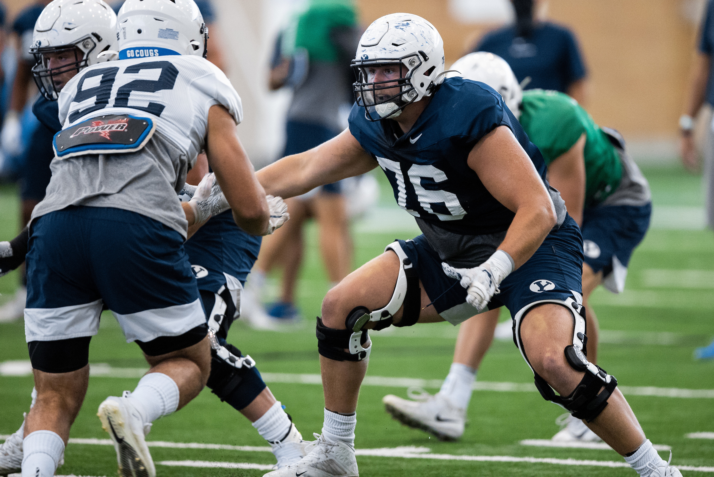 BYU offensive lineman Harris LaChance blocks Tyler Batty during training camp, Tuesday, Aug. 18, 2020 in the indoor practice facility in Provo.