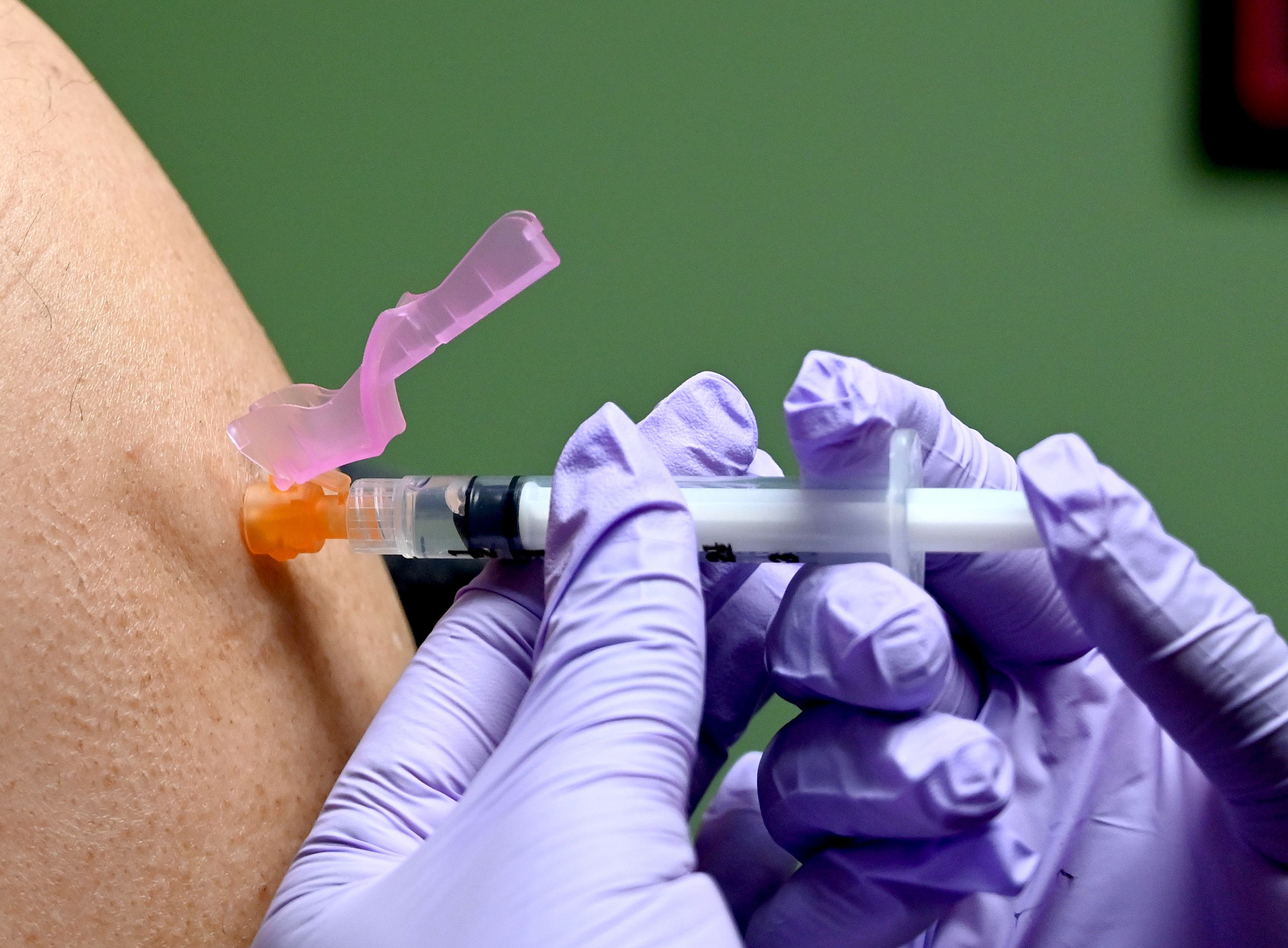 A man gets a flu shot at a health facility in Washington, DC January 2020.