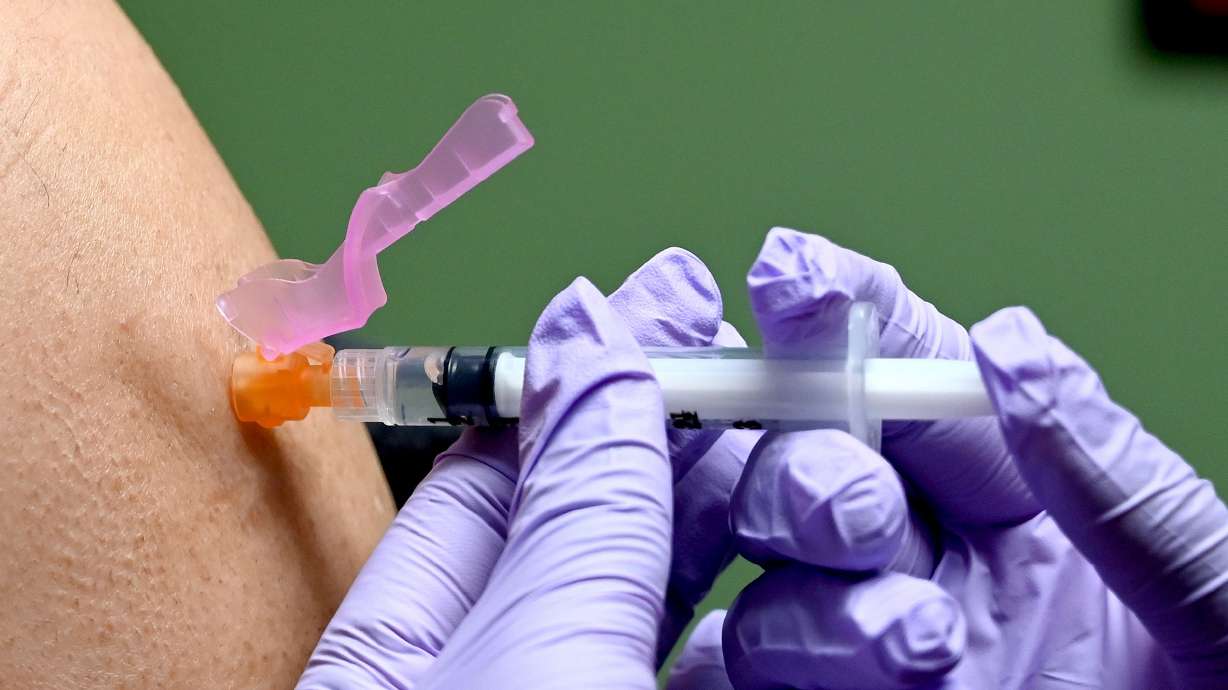 A man gets a flu shot at a health facility in Washington, DC January 2020.