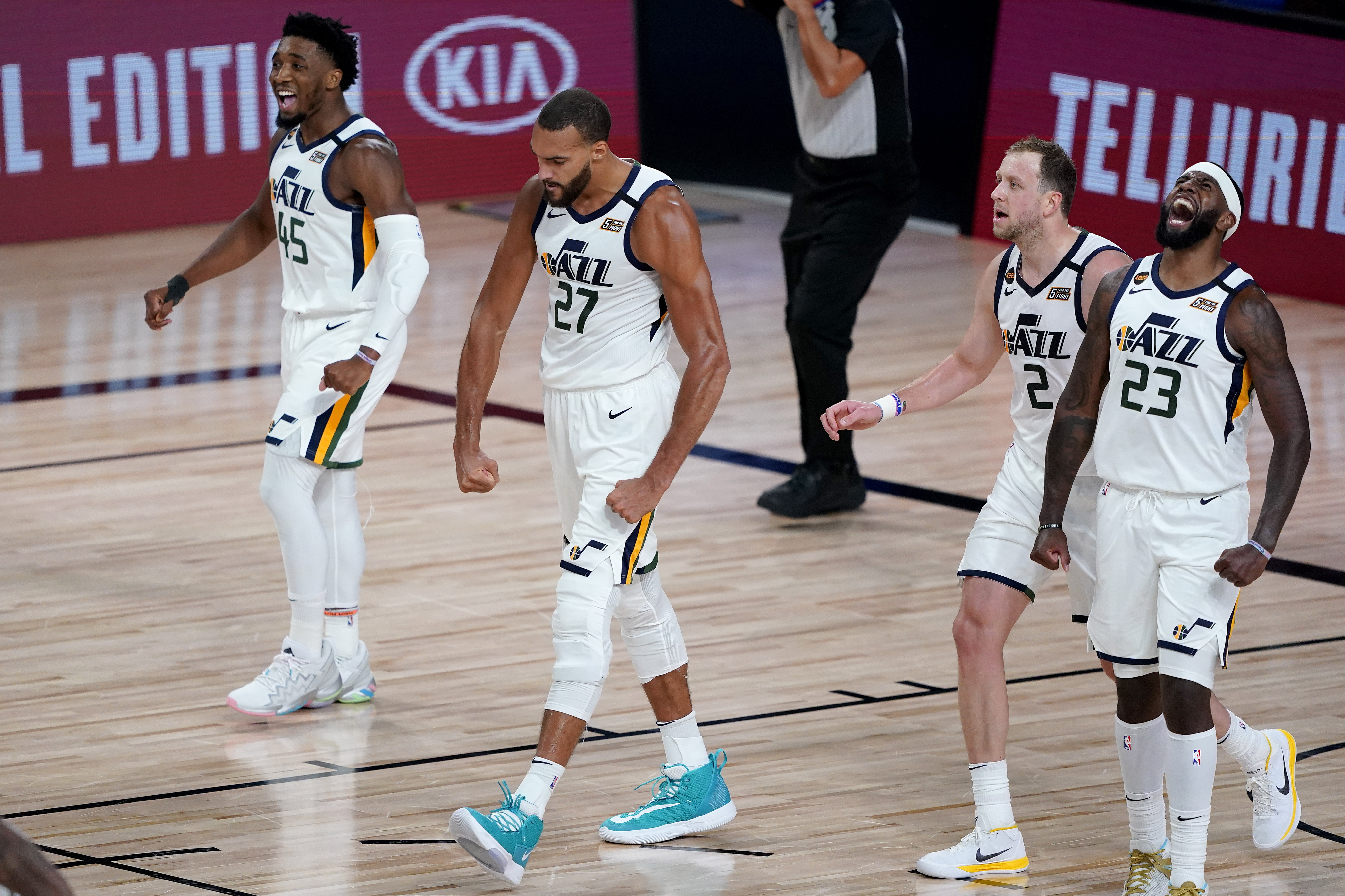 Utah Jazz's Rudy Gobert (27) celebrates a defensive stop with teammates Royce O'Neale (23), Joe Ingles (2) and Donovan Mitchell (45) during the first half of an NBA basketball first round playoff game against the Denver Nuggets, Monday, Aug. 3, 2020, in Lake Buena Vista, Fla.