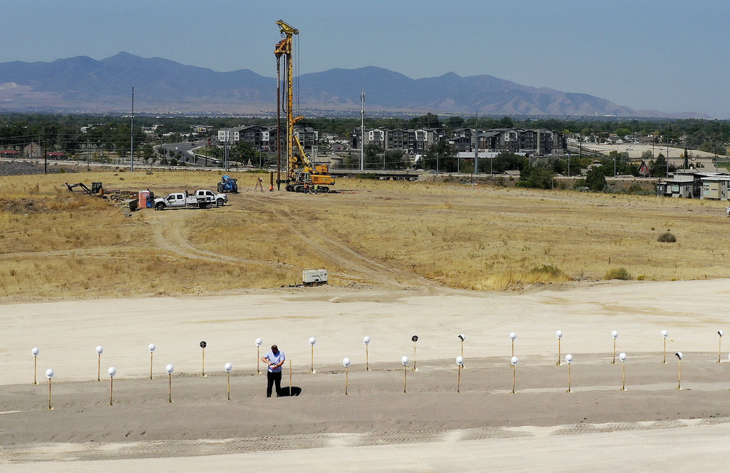 Ryan Bevan balances hard hats on shovels prior to a groundbreaking ceremony for Zions Bancorp.'s 400,000-square-foot technology campus in Midvale on Wednesday, Aug. 19, 2020.