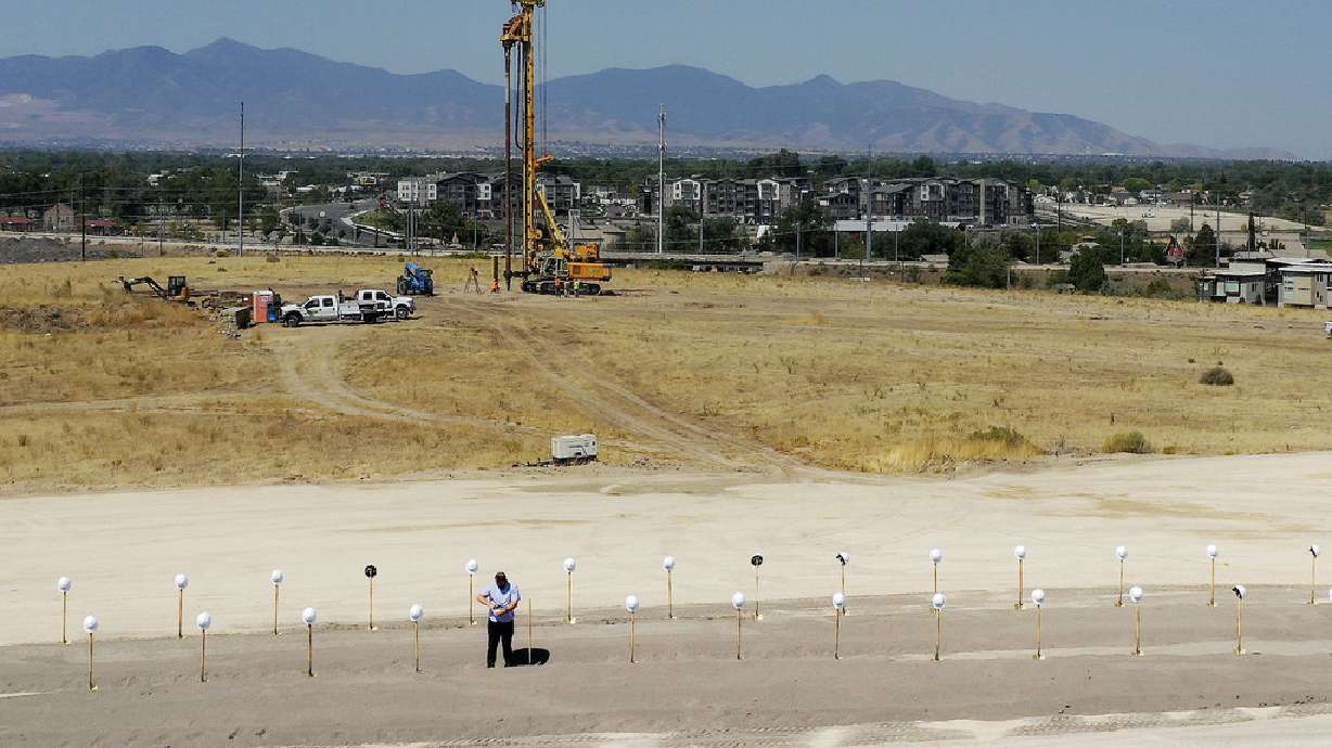 Ryan Bevan balances hard hats on shovels prior to a groundbreaking ceremony for Zions Bancorp.'s 400,000-square-foot technology campus in Midvale on Wednesday, Aug. 19, 2020.