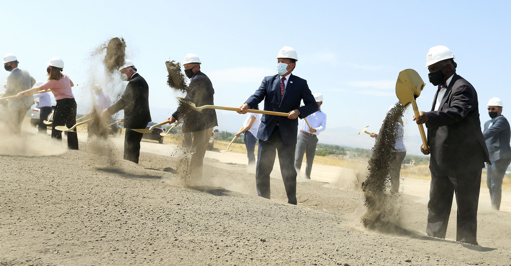 Gov. Gary Herbert, center, the Rev. France A. Davis, right, and other dignitaries shovel dirt during a groundbreaking ceremony for Zions Bancorp.'s 400,000-square-foot technology campus in Midvale on Wednesday, Aug. 19, 2020.