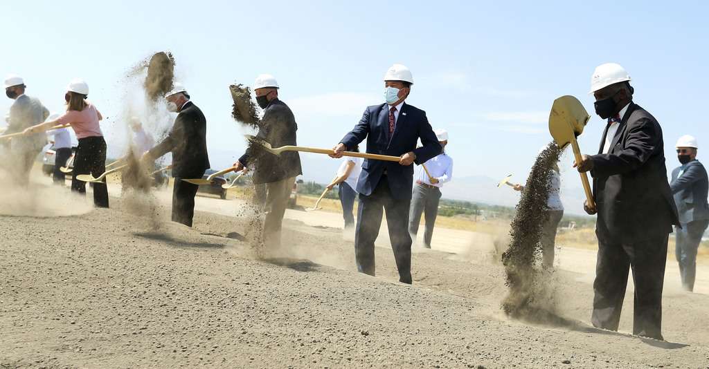 Gov. Gary Herbert, center, the Rev. France A. Davis, right, and other dignitaries shovel dirt during a groundbreaking ceremony for Zions Bancorp.'s 400,000-square-foot technology campus in Midvale on Wednesday, Aug. 19, 2020.