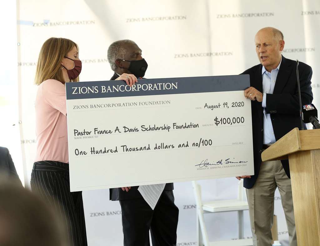 Jennifer Smith, chief information officer at Zions Bancorp., left, and Harris Simmons, chairman and CEO of Zions Bancorp., right, hand the Rev. France A. Davis, retired pastor of Calvary Baptist Church, a donation during the groundbreaking ceremony for Zions Bancorp.'s 400,000-square-foot technology campus in Midvale on Wednesday, Aug. 19, 2020. The Pastor France A. Davis Scholarship Foundation supports STEM students of color.