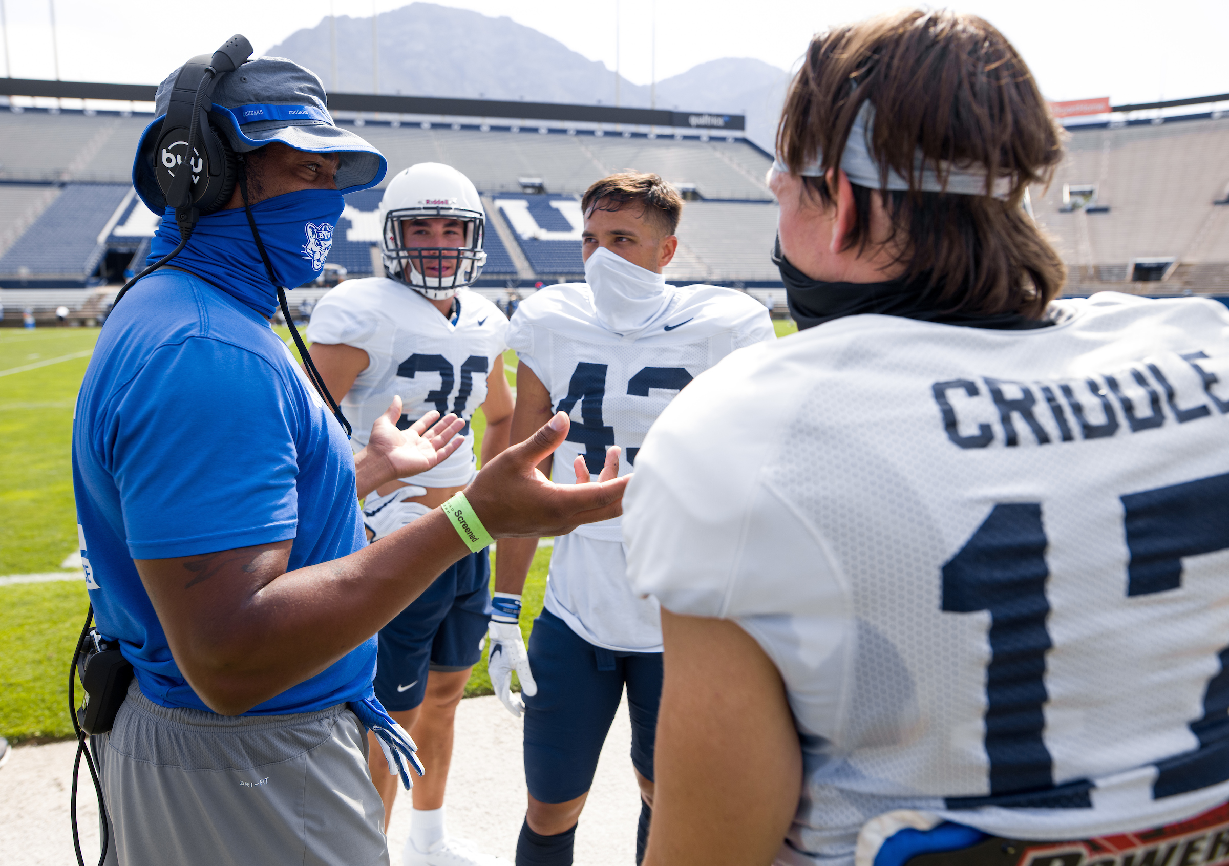 Coach Jenaro Gilford speaks with his BYU cornerbacks, including Matthew Criddle (17) after the final scrimmage of fall camp, Thursday, Aug. 20, 2020 at LaVell Edwards Stadium in Provo.