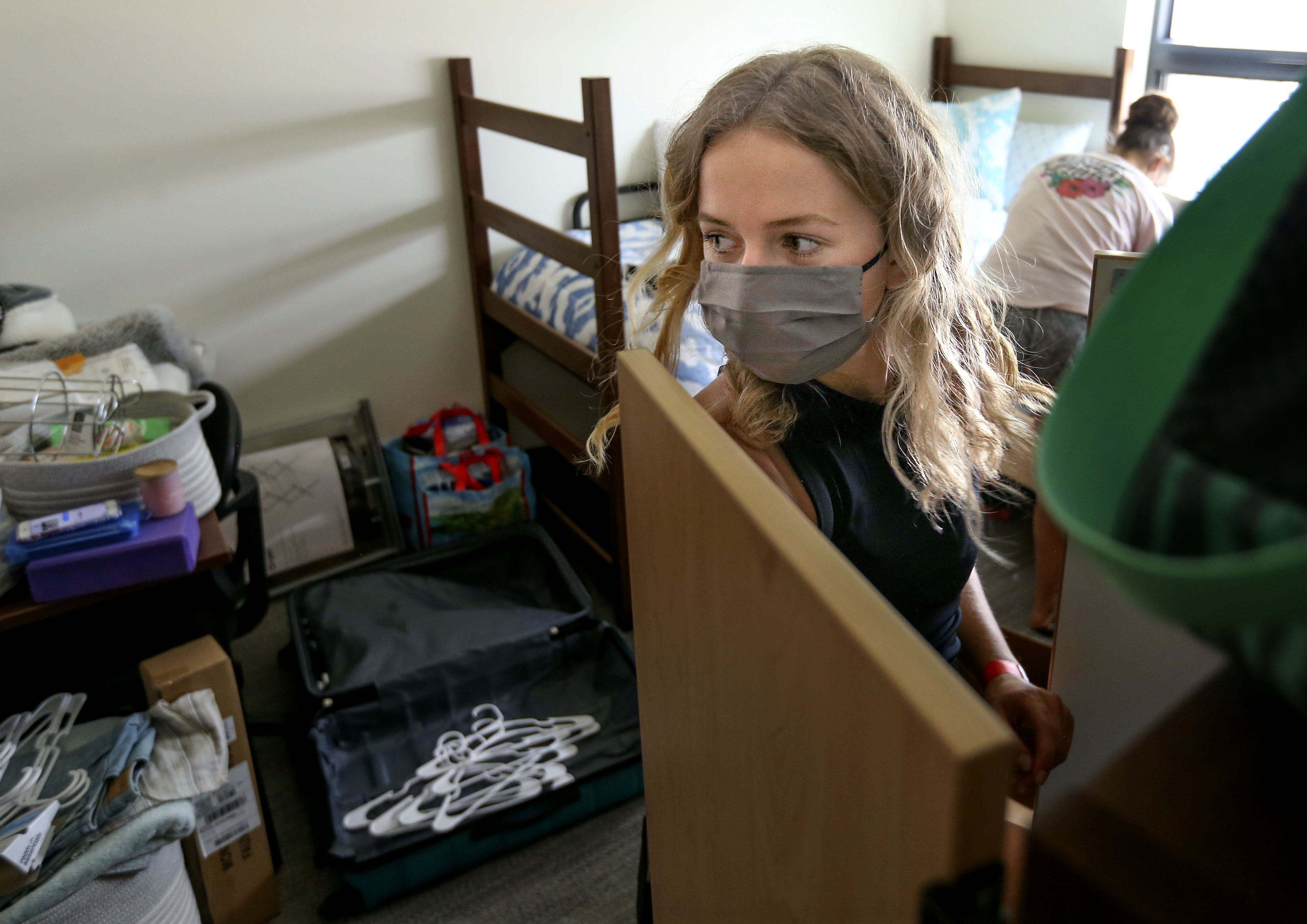 Victoria Medvedeva, of Idaho Falls, unpacks her belongings in her dorm room in Kahlert Village at the University of Utah in Salt Lake City on Thursday, Aug. 20, 2020.
