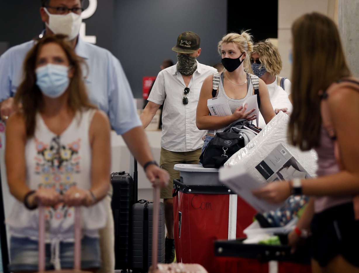 Parents and their children wait for an elevator as they move belongings into Kahlert Village at the University of Utah in Salt Lake City on Thursday, Aug. 20, 2020.