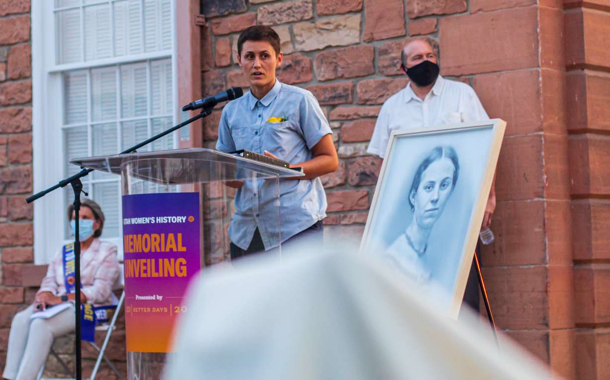 Kelsey Harrison speaks about the process of creating the women's suffrage history memorial outside of the Salt Lake Council Hall during an unveiling ceremony on Thursday, Aug. 20, 2020. Harrison and Jason Manley, right, were the artists picked to design the memorial.
