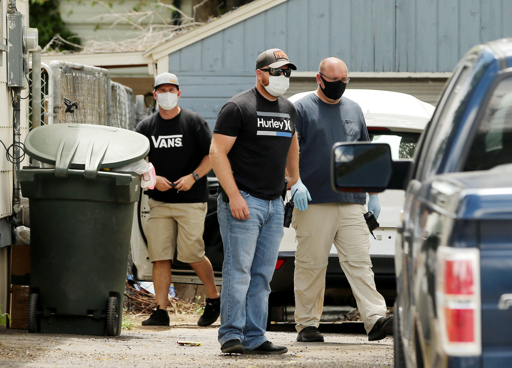Members of law enforcement work at a home near 1700 Indiana Avenue in Salt Lake City on Friday, May 29, 2020, where a suspect in a fatal shooting near 2900 South and 3000 West in West Valley City was arrested.